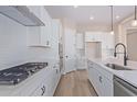 Bright kitchen featuring white cabinets, quartz countertops and stainless steel appliances at 23942 N 171St Dr, Surprise, AZ 85387