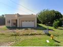 Newly built home with a one-car garage and grassy yard at 909 W Tamarisk St, Phoenix, AZ 85041