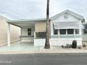 Mobile home with covered porch and landscaping at 60 S Jacknife Dr, Apache Junction, AZ 85119