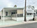 Mobile home with covered porch and landscaping at 60 S Jacknife Dr, Apache Junction, AZ 85119