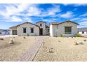 House exterior with inviting walkway and landscaping at 630 N Star Ct, Apache Junction, AZ 85119