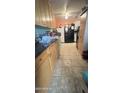 Bright kitchen with wood cabinets, tile floor, and stainless steel appliances at 915 W Tamarisk St, Phoenix, AZ 85041