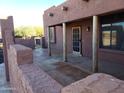 Covered patio with wooden posts and adjacent wall at 25645 W Blue Sky Dr, Wittmann, AZ 85361