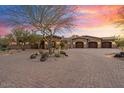 Luxury home exterior at sunset, featuring a large courtyard and three-car garage at 29906 N Miradar Ct # 18&19, Scottsdale, AZ 85262