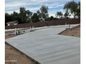 New home construction site showing poured concrete foundation and landscaping at 10722 E Dragoon Cir, Mesa, AZ 85208