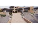Modern home exterior with stone accents and a two-car garage at 37445 N 104Th Pl, Scottsdale, AZ 85262