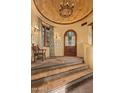 Elegant entryway with a coffered ceiling, arched doorway, and tiled steps at 10040 E Happy Valley Rd # 676, Scottsdale, AZ 85255