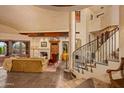 Spacious living room with a grand staircase, fireplace, and high ceilings at 10040 E Happy Valley Rd # 676, Scottsdale, AZ 85255