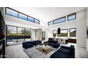 Open-concept living room with kitchen and view of backyard at 10977 E Oberlin Way, Scottsdale, AZ 85262