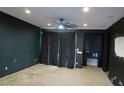 Spacious bonus room with dark walls and ceiling fan at 1069 W Elm Ave, Coolidge, AZ 85128