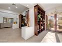 Spacious living room with built-in shelves and access to a backyard patio at 3105 S Amble Pass, Gold Canyon, AZ 85118