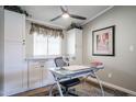 Home office space with white cabinets, glass desk, and window blinds at 11596 W Sierra Dawn Blvd # 80, Surprise, AZ 85378