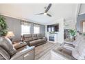 Living room features brown leather couches, a fireplace, and a large TV at 11596 W Sierra Dawn Blvd # 80, Surprise, AZ 85378