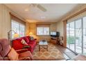 Living room with red couch, wood floors, and access to patio at 8421 E Main St # 106, Mesa, AZ 85207
