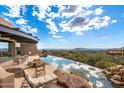 Infinity pool with mountain views and patio furniture at 11108 E Mariola Way, Scottsdale, AZ 85262