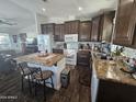 Modern kitchen featuring dark wood cabinets and an island at 650 N Hawes Rd # 3202, Mesa, AZ 85207