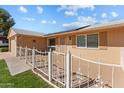 House exterior with solar panels, fence, and driveway at 10712 W Cameo Dr, Sun City, AZ 85351