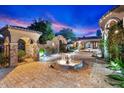 Luxury estate with courtyard featuring fountain and stonework at 10629 E Troon North Dr, Scottsdale, AZ 85262
