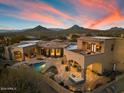 Aerial view of a large estate home with pool and outdoor kitchen at 10629 E Troon North Dr, Scottsdale, AZ 85262