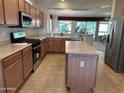 Modern kitchen featuring stainless steel appliances and an island at 17626 W Calistoga Dr, Surprise, AZ 85387