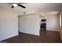 Open living room and kitchen with dark wood floors at 9222 N 35Th Ave # 1, Phoenix, AZ 85051