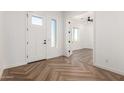 Bright entryway with herringbone wood-look tile floor at 31712 N 169Th Ave, Surprise, AZ 85387
