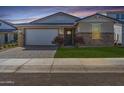 Modern Farmhouse style home with stone facade and landscaped yard at 17227 W Middlebury St, Surprise, AZ 85388