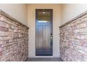 Modern front door entry with stonework at 17227 W Middlebury St, Surprise, AZ 85388