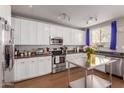 Modern white kitchen with stainless steel appliances and dark countertops at 2825 N 42Nd St # 11, Phoenix, AZ 85008