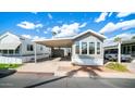 Mobile home exterior, front view, showing landscaping and driveway at 690 Felspar Dr, Apache Junction, AZ 85119
