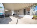 Covered patio with seating area, storage shed, and BBQ grill at 690 Felspar Dr, Apache Junction, AZ 85119