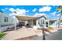 Mobile home exterior with covered carport and landscaping at 690 Felspar Dr, Apache Junction, AZ 85119