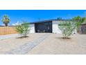 Mid-century modern home with a landscaped front yard and walkway at 1212 E Indianola Ave, Phoenix, AZ 85014