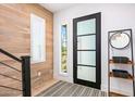 Bright entryway with wood wall, modern door, and stylish rug at 37200 N Cave Creek Rd # 2124, Scottsdale, AZ 85262