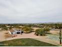 Aerial view of property showcasing the house, expansive grounds, and distant mountain views at 29429 N 64Th St, Cave Creek, AZ 85331