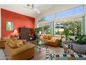 Relaxing living room with leather sofas, large windows, and an accent wall at 18059 W Hickcox Dr, Surprise, AZ 85374