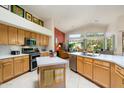Open kitchen with island, stainless steel appliances, and views of living room at 18059 W Hickcox Dr, Surprise, AZ 85374
