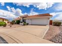 Single-story house with a two-car garage and desert landscaping at 8351 E Monte Ave, Mesa, AZ 85209