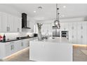 Modern kitchen with white cabinets and large island at 17316 W Wildwood St, Surprise, AZ 85388