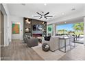 Spacious living room with modern fireplace and access to backyard at 17316 W Wildwood St, Surprise, AZ 85388