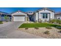 Modern home with white exterior, grey paver driveway, and landscaping at 17316 W Wildwood St, Surprise, AZ 85388