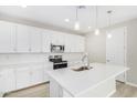 Modern kitchen featuring white cabinets, quartz countertops, and stainless steel appliances at 18741 E Elizar Dr, Gold Canyon, AZ 85118