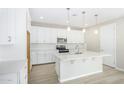Modern kitchen with white shaker cabinets, quartz countertops, and an island at 18741 E Elizar Dr, Gold Canyon, AZ 85118