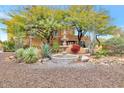 Landscaped front yard with a fountain and mature trees at 6310 E Dove Valley Rd, Cave Creek, AZ 85331