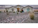 Single-story home with desert landscaping and stone accents at 13621 W Tuckey Ct, Glendale, AZ 85307
