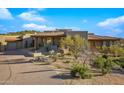Stunning desert contemporary home with a large covered patio and attached garage at 9917 E Filaree Ln, Scottsdale, AZ 85262