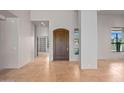 Spacious entryway with flagstone flooring, a wood door, and built-in shelving at 9917 E Filaree Ln, Scottsdale, AZ 85262