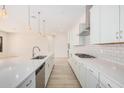 Modern kitchen with white cabinets and a large island at 24041 N 171St Ln, Surprise, AZ 85387