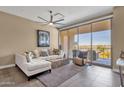 Living room features L-shaped sofa, balcony access, and city views at 15215 N Kierland Blvd # 436, Scottsdale, AZ 85254