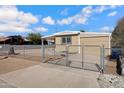 Tan single story home with chain link fence and gate at 225 N 89Th St, Mesa, AZ 85207